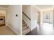 Elegant foyer featuring hardwood floors, stairs, and a view of the front entrance at 3823 Dragon Fly Ln, Loganville, GA 30052