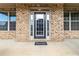 Inviting front entrance with a black door, sidelights, transom window, and 'Home' welcome mat at 3823 Dragon Fly Ln, Loganville, GA 30052
