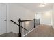 Hallway with carpet, black railing, and white walls at 3823 Dragon Fly Ln, Loganville, GA 30052