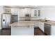 Open kitchen with white cabinets, stainless steel appliances, and a large center island at 3823 Dragon Fly Ln, Loganville, GA 30052