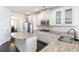 Charming kitchen with a center island, stainless steel appliances, and sleek white cabinets at 3823 Dragon Fly Ln, Loganville, GA 30052
