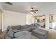 Open concept living room with a sectional sofa, ceiling fan, and access to the kitchen at 3823 Dragon Fly Ln, Loganville, GA 30052