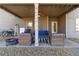 Covered patio area with cozy seating arrangement, ceiling fan, and string lights, perfect for outdoor relaxation at 3823 Dragon Fly Ln, Loganville, GA 30052