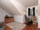Attic room with a sewing station and unique sloped ceiling at 517 Sheritan Sw Way, Smyrna, GA 30082