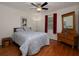 Cozy bedroom featuring hardwood floors, ceiling fan, and comfortable furnishings at 517 Sheritan Sw Way, Smyrna, GA 30082
