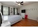 Bedroom featuring wood floor, two windows, and a ceiling fan at 517 Sheritan Sw Way, Smyrna, GA 30082