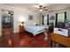 Bedroom featuring hardwood floors, ceiling fan, and adjacent living area at 517 Sheritan Sw Way, Smyrna, GA 30082