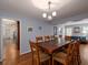 Dining room with a large wooden table, seating for eight, and stylish lighting fixture at 517 Sheritan Sw Way, Smyrna, GA 30082