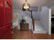 Bright foyer featuring hardwood floors, a staircase with wooden banister, and decorative lighting at 517 Sheritan Sw Way, Smyrna, GA 30082