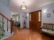 A welcoming foyer with hardwood floors, a staircase, and a view into a living area at 517 Sheritan Sw Way, Smyrna, GA 30082
