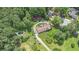 Aerial shot of a home with pool, outbuildings, circular drive and surrounded by mature trees at 2452 Camp Mitchell Rd, Grayson, GA 30017