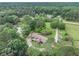 An expansive aerial view showcasing the home nestled in beautiful wooded acreage at 2452 Camp Mitchell Rd, Grayson, GA 30017