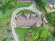 Aerial view of home featuring a circular driveway and luscious landscaping at 2452 Camp Mitchell Rd, Grayson, GA 30017