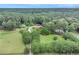 Aerial view of a house on a vast, gated property with mature trees and landscaping at 2452 Camp Mitchell Rd, Grayson, GA 30017