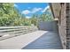 Large wooden back deck overlooking a tree-filled backyard, perfect for entertaining and outdoor living at 2452 Camp Mitchell Rd, Grayson, GA 30017