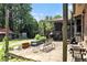 Outdoor stone patio featuring a dining area and comfortable seating, perfect for entertaining and relaxing at 2452 Camp Mitchell Rd, Grayson, GA 30017
