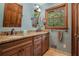 Bathroom featuring a double sink vanity with granite countertop and wooden cabinets at 2452 Camp Mitchell Rd, Grayson, GA 30017