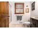 Cozy bathroom with traditional vanity, framed window and decorative art at 2452 Camp Mitchell Rd, Grayson, GA 30017