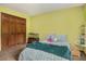 Inviting bedroom with yellow walls, wooden closet doors, and a fish tank at 2452 Camp Mitchell Rd, Grayson, GA 30017