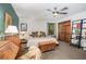 Bright bedroom featuring a ceiling fan, wood closet doors, and decorative accents at 2452 Camp Mitchell Rd, Grayson, GA 30017