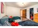 Bedroom featuring two twin beds, a table, and closet space for storage at 2452 Camp Mitchell Rd, Grayson, GA 30017