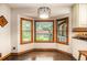 Charming breakfast nook with hardwood floors and large windows showcasing the outdoor view at 2452 Camp Mitchell Rd, Grayson, GA 30017