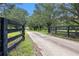 A gated, tree-lined driveway leading to a charming home at 2452 Camp Mitchell Rd, Grayson, GA 30017