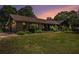 Charming brick home featuring lush green lawn and mature landscaping with a warm sunset backdrop at 2452 Camp Mitchell Rd, Grayson, GA 30017