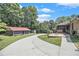 Well-maintained property with a shed, patio area, and a long driveway, surrounded by a lush green lawn at 2452 Camp Mitchell Rd, Grayson, GA 30017