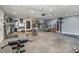 Fully-equipped home gym features a variety of exercise machines, weights, and a punching bag for a complete workout experience at 2452 Camp Mitchell Rd, Grayson, GA 30017