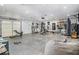 Extensive home gym features ample space and equipment, including free weights, a punching bag, and a garage door entrance at 2452 Camp Mitchell Rd, Grayson, GA 30017