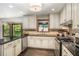 Bright kitchen with white cabinets, stainless appliances, dark countertops and charming details at 2452 Camp Mitchell Rd, Grayson, GA 30017