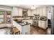 Well-lit kitchen featuring black countertops, stainless steel appliances, and wooden floors and cabinets at 2452 Camp Mitchell Rd, Grayson, GA 30017