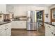Well-equipped kitchen with granite countertops, white cabinets, stainless steel appliances and hardwood floors at 2452 Camp Mitchell Rd, Grayson, GA 30017