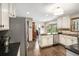 An expansive kitchen with stainless steel appliances, white cabinets, and hardwood floors at 2452 Camp Mitchell Rd, Grayson, GA 30017