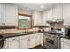 Well-lit kitchen with stainless steel appliances and dark countertops at 2452 Camp Mitchell Rd, Grayson, GA 30017