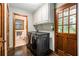 Laundry room equipped with modern washer and dryer, storage cabinets and backyard access at 2452 Camp Mitchell Rd, Grayson, GA 30017
