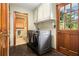 Well-equipped laundry room with modern washer/dryer and ample cabinet space at 2452 Camp Mitchell Rd, Grayson, GA 30017