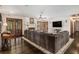 Spacious living room with a fireplace, hardwood floors, and a large sectional sofa at 2452 Camp Mitchell Rd, Grayson, GA 30017