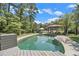 Inviting backyard pool with a covered gazebo and lounge chairs, perfect for relaxation and entertainment at 2452 Camp Mitchell Rd, Grayson, GA 30017