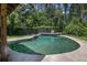 Backyard pool surrounded by mature trees and lush greenery offers a tranquil retreat for relaxation and recreation at 2452 Camp Mitchell Rd, Grayson, GA 30017