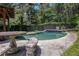 Inviting pool and patio area surrounded by lush landscaping provides a serene oasis for relaxation and outdoor enjoyment at 2452 Camp Mitchell Rd, Grayson, GA 30017