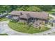 Backyard of brick home with a rustic deck, screened porch, patio, and a circular drive at 2452 Camp Mitchell Rd, Grayson, GA 30017