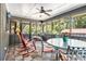 Relaxing screened porch with wood flooring, ceiling fan, and outdoor seating, perfect for enjoying the outdoors at 2452 Camp Mitchell Rd, Grayson, GA 30017