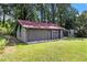 Exterior view of shed with red roof, gray siding, screened porch, and green grass at 2452 Camp Mitchell Rd, Grayson, GA 30017