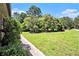 Expansive grassy front yard featuring mature trees, a covered structure and a sidewalk leading from the house at 2452 Camp Mitchell Rd, Grayson, GA 30017