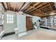 Unfinished basement with storage shelves, exposed ceiling, and walkout to backyard at 2917 Townley Cir, Atlanta, GA 30340