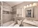 Bathroom featuring tub with tiled surround, updated vanity, granite counter, and modern fixtures at 2917 Townley Cir, Atlanta, GA 30340