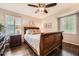 Comfortable bedroom with a ceiling fan, plantation shutters, and a wood sleigh bed on hardwood floors at 2917 Townley Cir, Atlanta, GA 30340