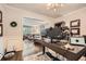 Comfortable home office open to the living room with a large desk and modern lighting at 2917 Townley Cir, Atlanta, GA 30340